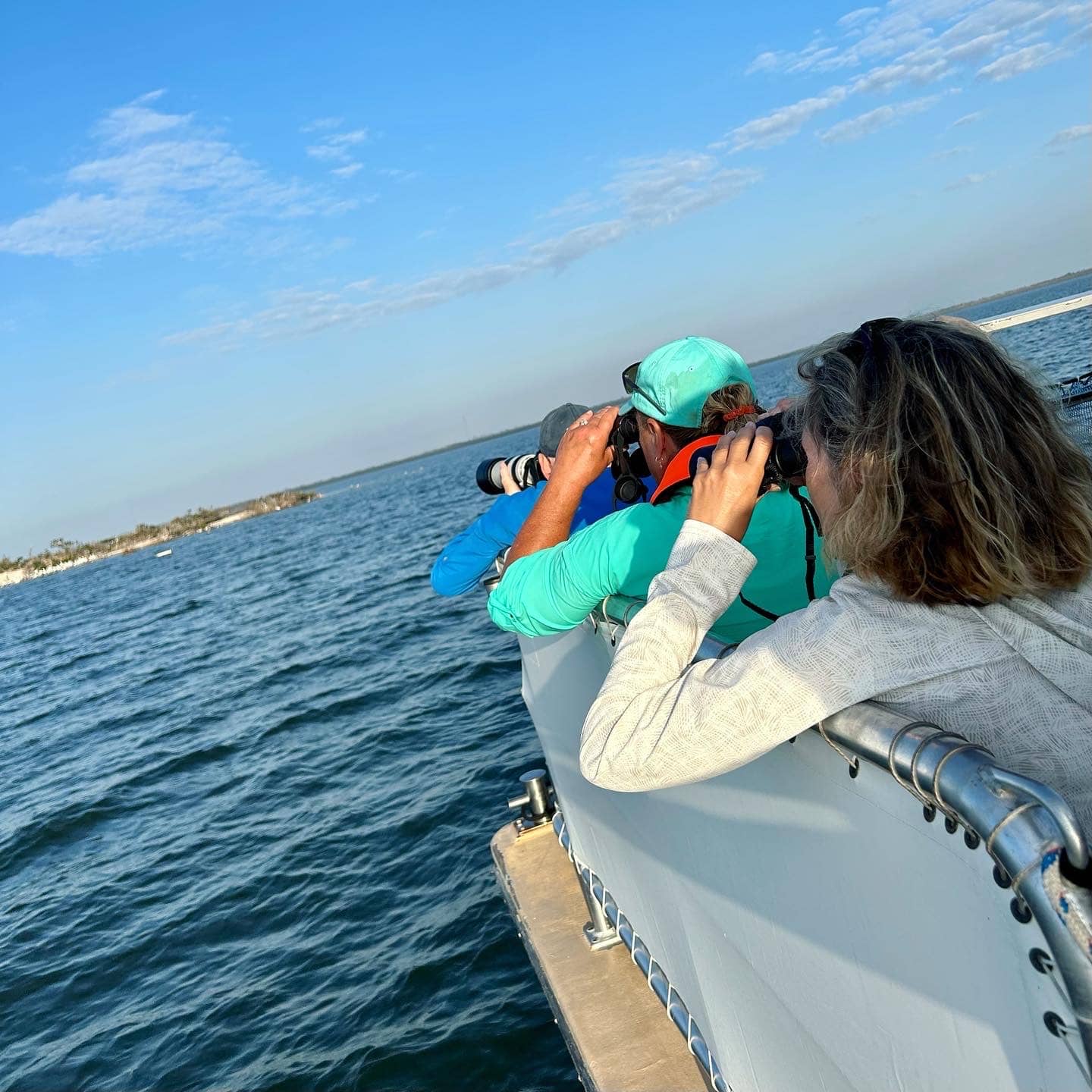 image of people with binoculars on boat