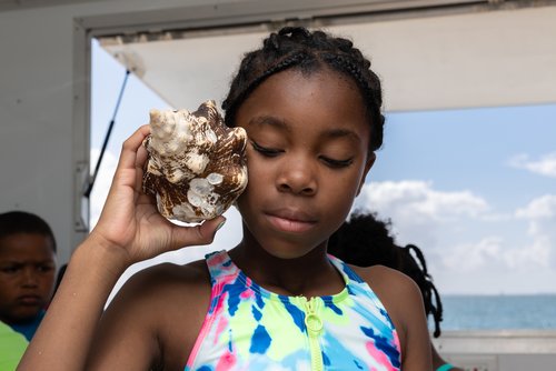 Girl holding seashell