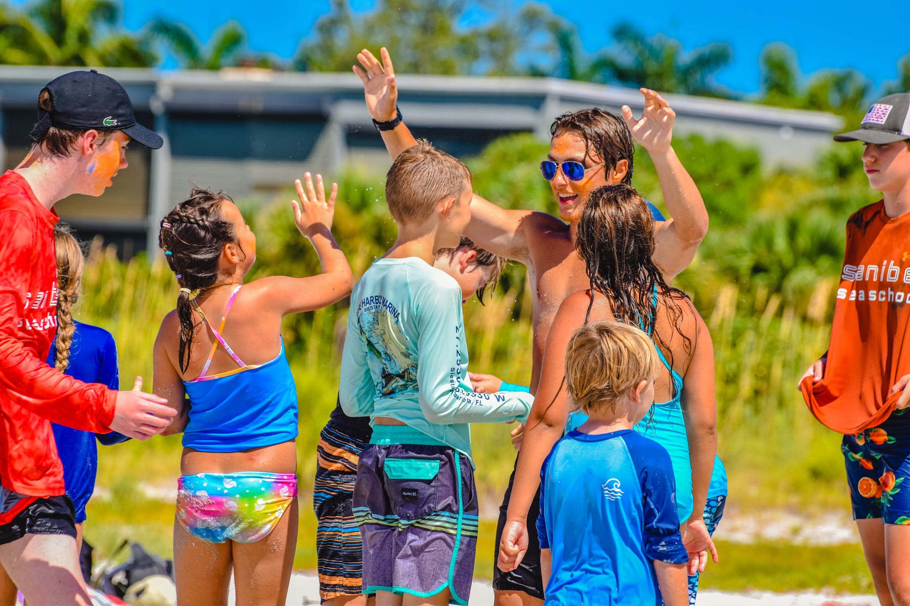 Sanibel Sea School counselors in training and campers high fives
