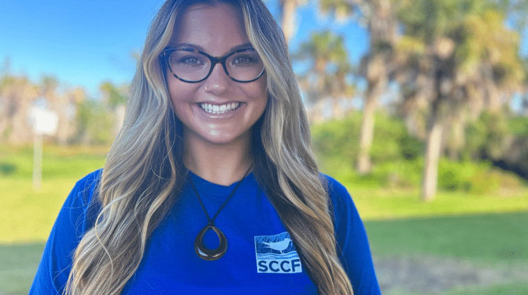 woman smiling outdoors with SCCF shirt