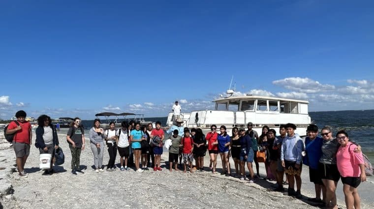 group of students on beach for no child left on shore field trip