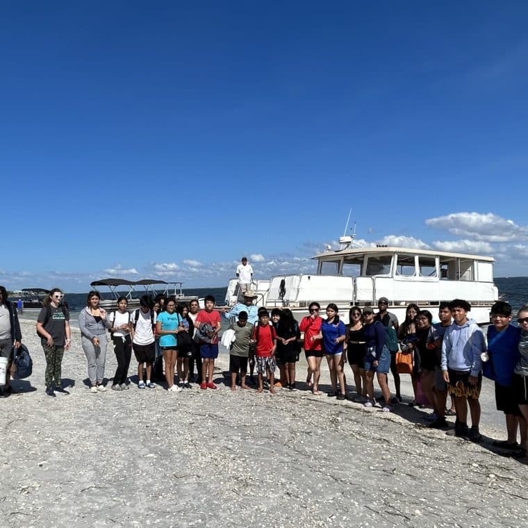 group of students on beach for no child left on shore field trip