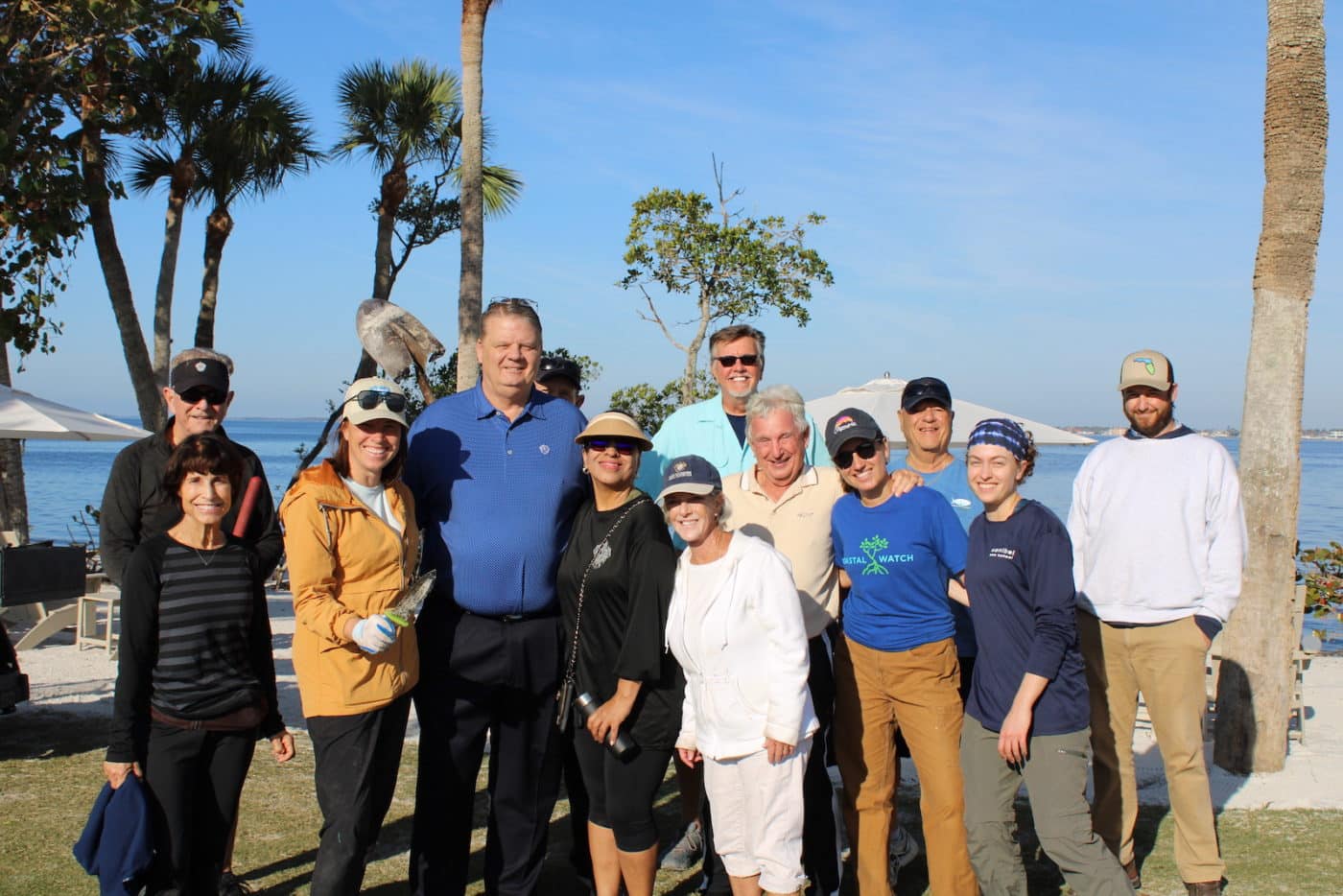 Group smiling with ocean in  the background